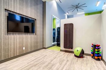 a games room with a tv and a ball on the floor